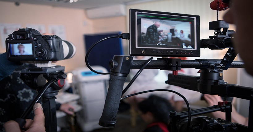 two cameras behind the scenes at a film set